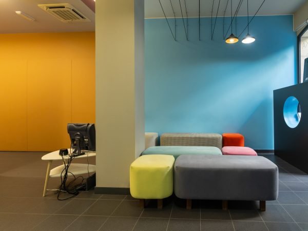 The Waiting room of a modern dental clinic, without people with colored sofas in a city
